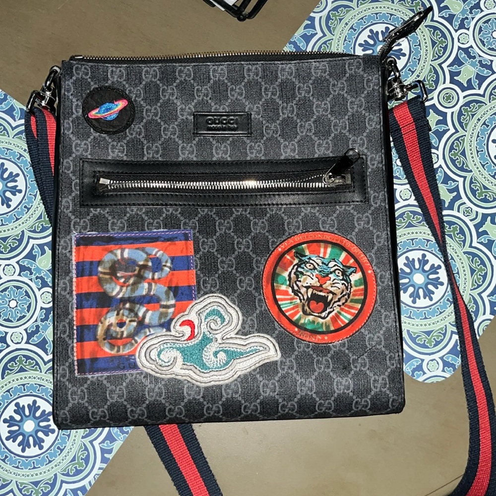Men’s custom Gucci Bag, color black,gray with red stitching.